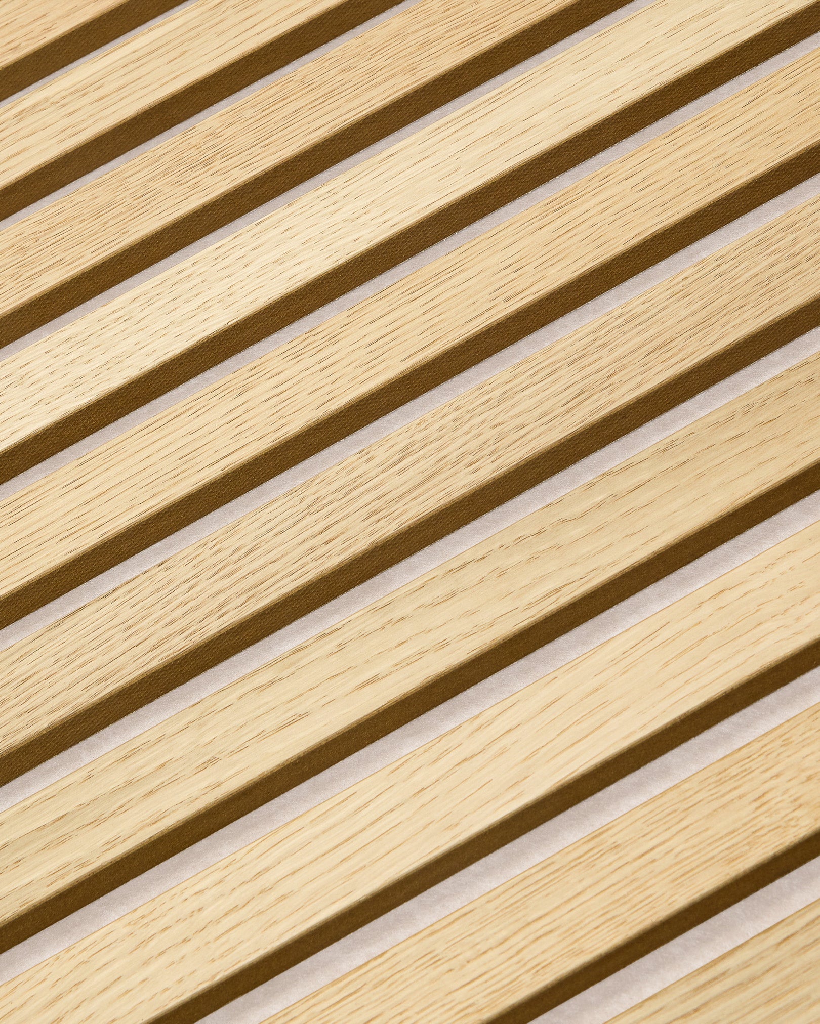 Close-up of WoodUpp Akupanel acoustic panel in Classic Oak with light beige felt, 240x60 cm, featuring Nordic slatted wood texture and sound-absorbing design.