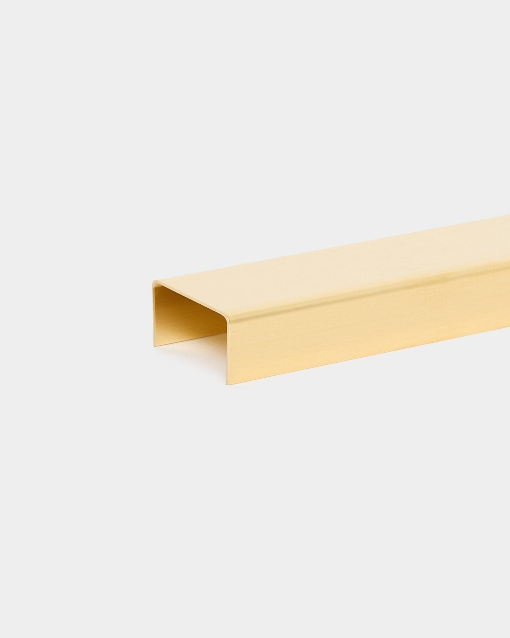 The Liva Cover in brass, 20 cm by WoodUpp is a gold U-shaped metal channel designed as a finishing cover for Akupanel acoustic wood panels.