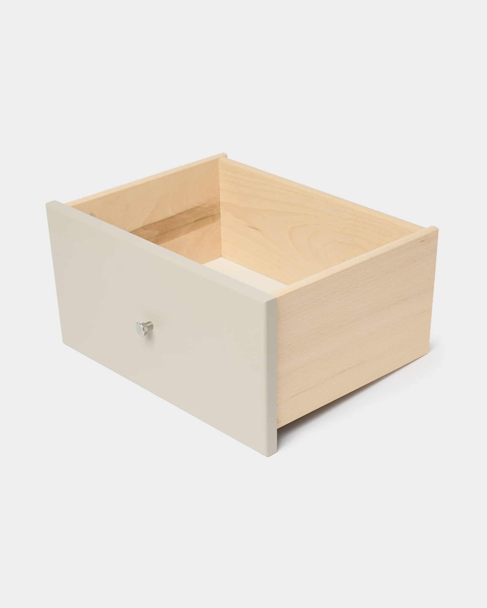 Tiroir de bibliothèque WoodUpp Arka, de couleur beige avec une façade et un bouton blancs, conçu pour un rangement fermé, présenté sur un fond blanc uni.