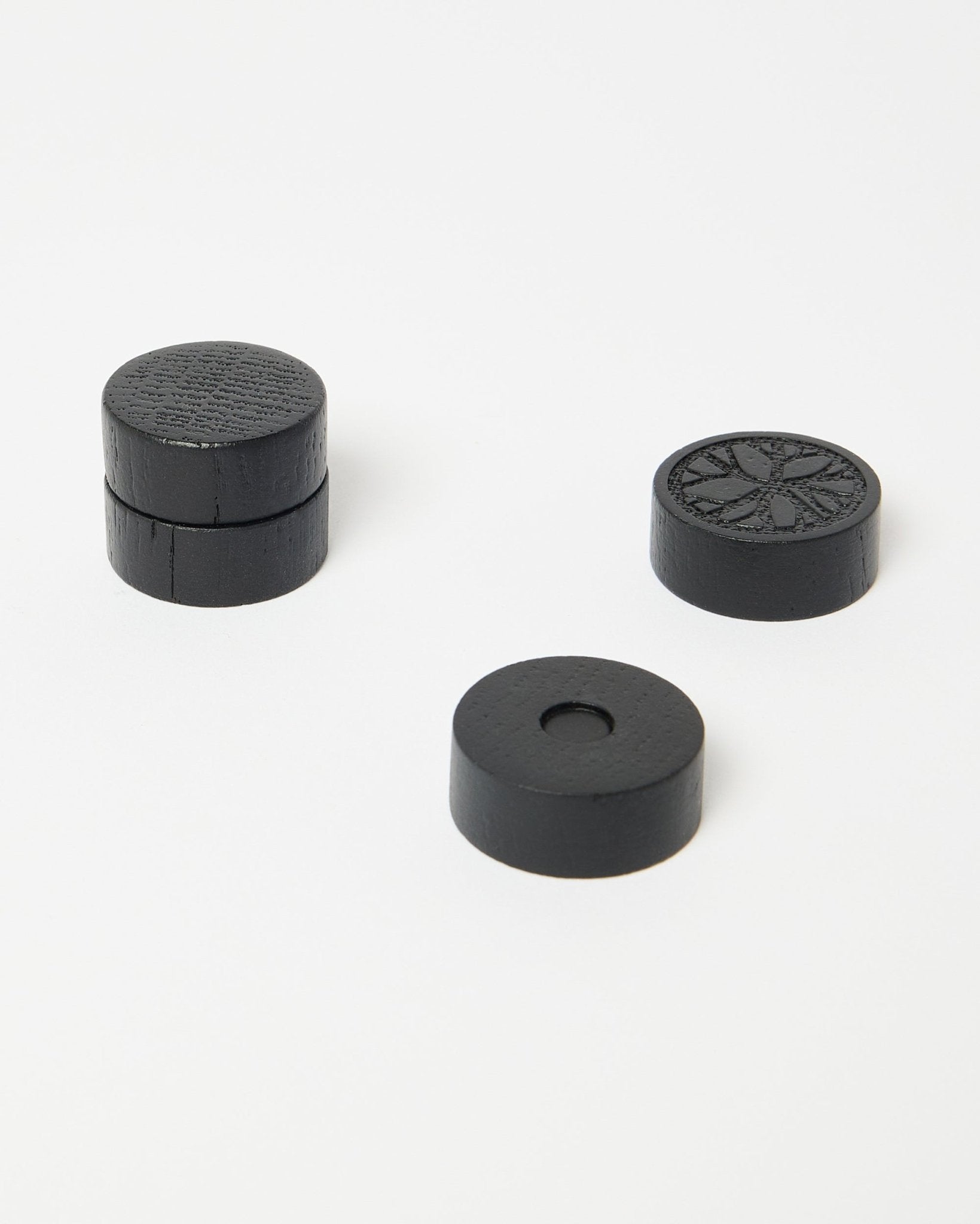 Set of four black oak Norr magnets from WoodUpp, part of the CREATE accessory collection, neatly positioned on a clean white surface.