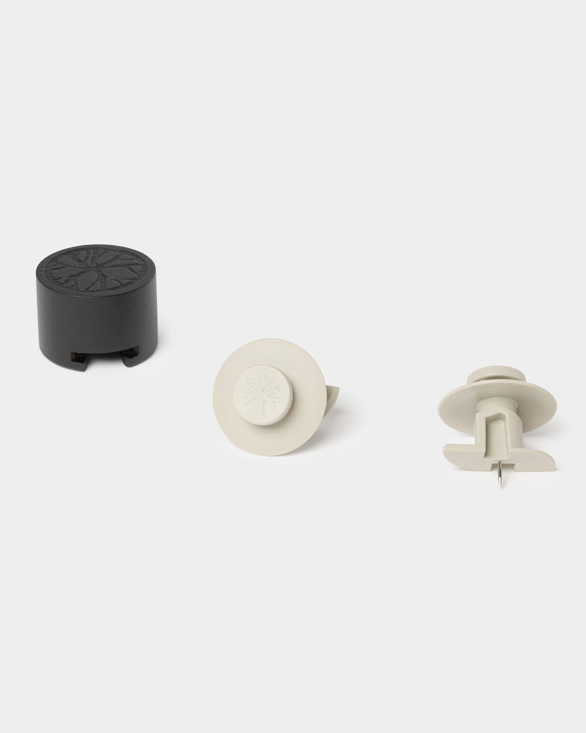 Three beige Dupps wall fasteners by WoodUpp, shown from multiple angles on a plain light background. Accessory for mounting Akupanel acoustic panels.