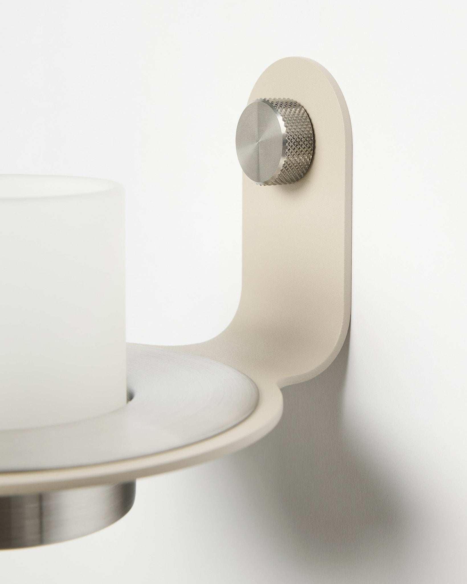 Minimalist Norr Candle Holder in beige and stainless steel by WoodUpp, shown as an accessory for Akupanel acoustic slatwall panels.