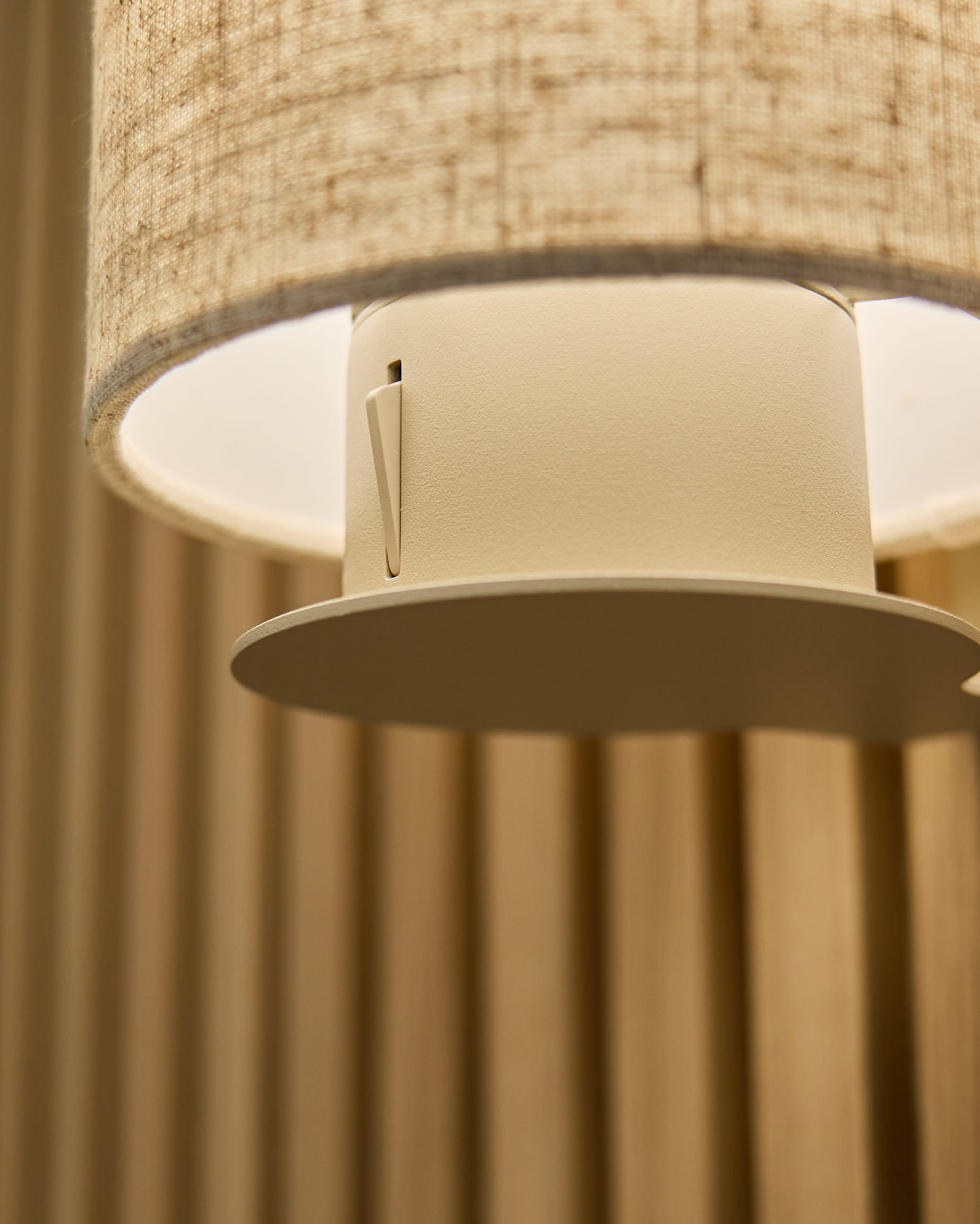 Close-up of the Feya Wall Lamp in Beige/Beige by WoodUpp, with a linen-cotton shade and cylindrical fixture mounted on vertical beige acoustic panels.