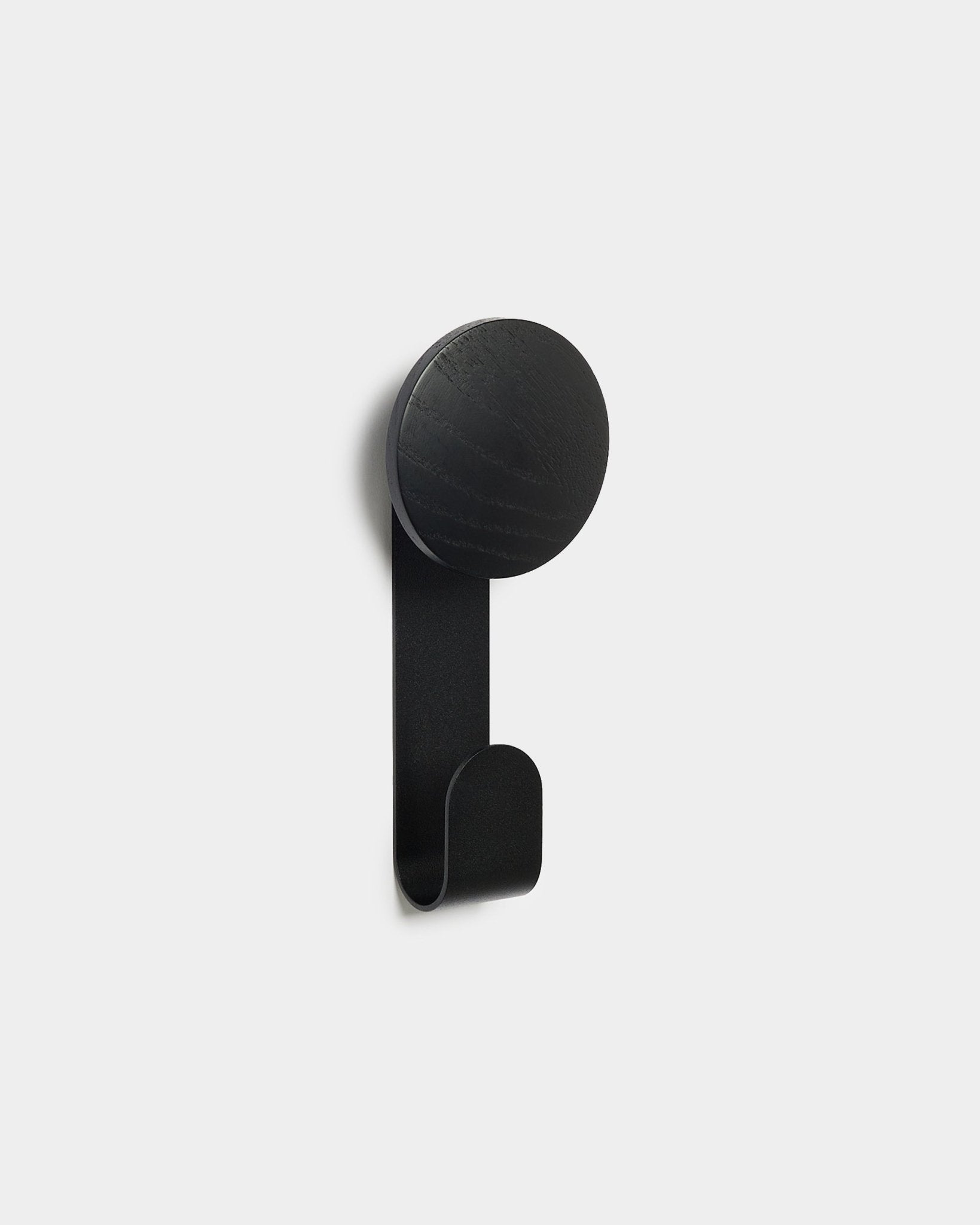 Linn Vertical Hanger in Black Oak by WoodUpp, a minimalist accessory designed for hanging items on Akupanel acoustic wood panels.