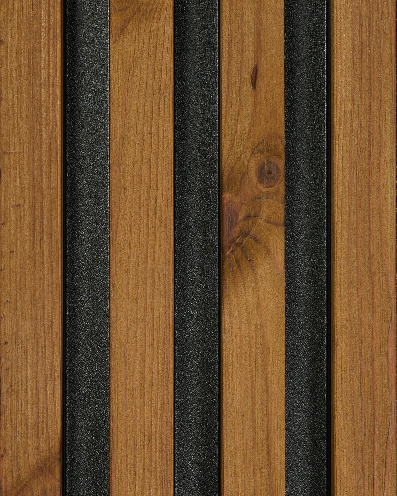 Close-up of WoodUpp Aluwood facade panel sample in oiled brown finish (45.7 x 27 cm), highlighting natural wood grain and black textured strips.