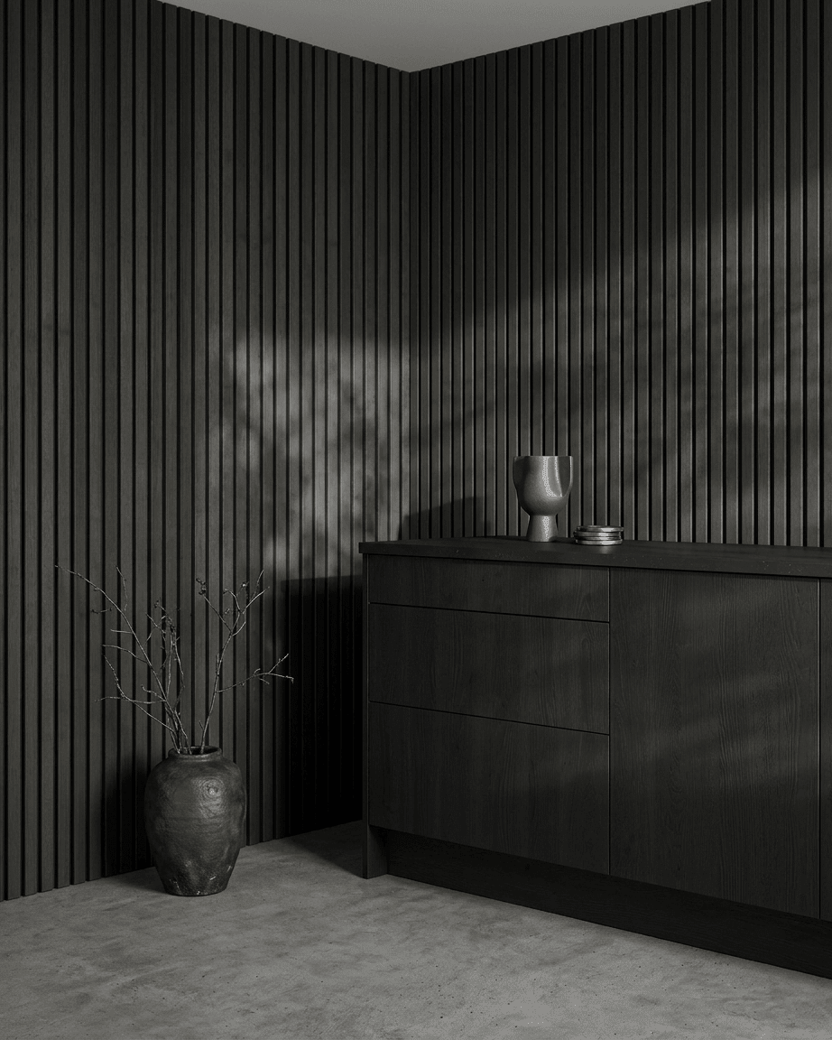 Minimalist room with WoodUpp Akupanel acoustic panel in Black Ash and black felt, complemented by Scandinavian decor elements and ceramic accents.