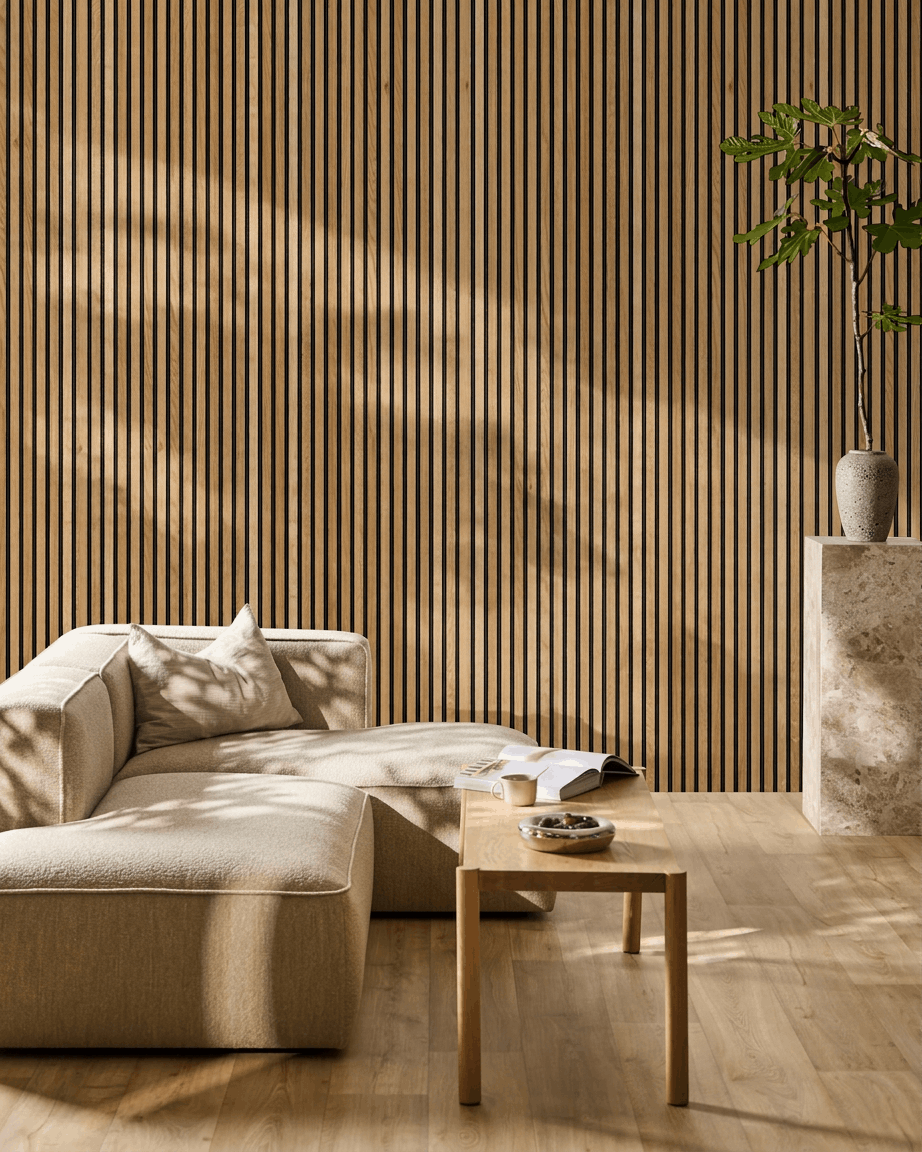 Scandinavian-style living room with a beige sectional, WoodUpp Akupanel acoustic panel in Rustic Brown Oak on the wall, small wooden table, and tall plant.