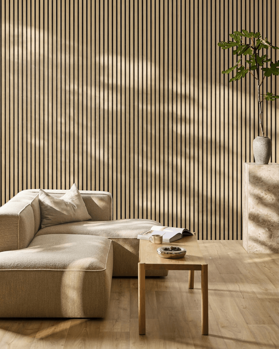 Minimalist living room with beige sofa, coffee table, and plant placed against a WoodUpp Akupanel acoustic wall panel in Southern Oak  Black Felt.